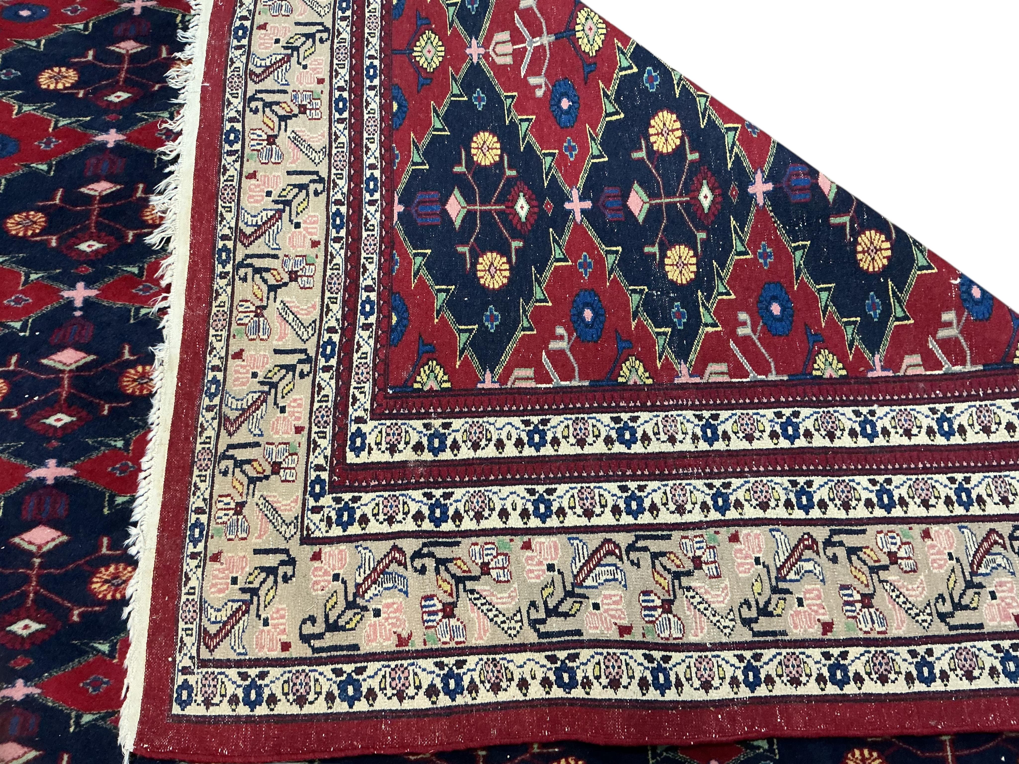 An Afghan red ground carpet, 270 x 188cm